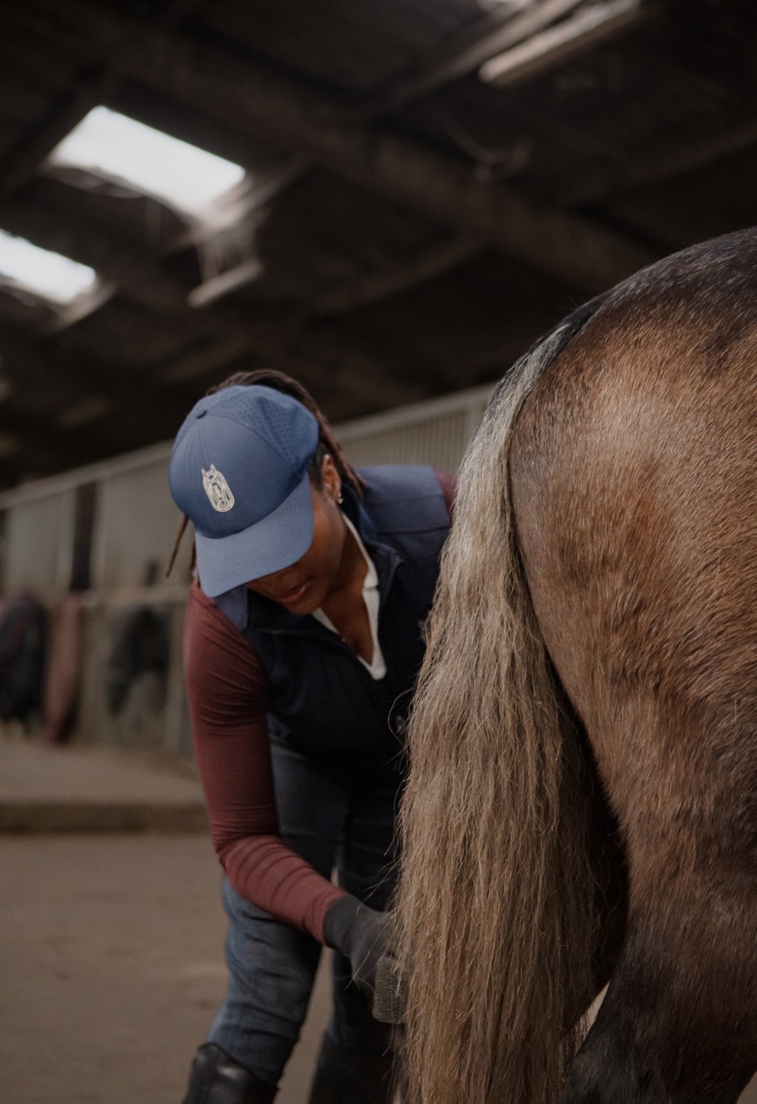 A Champion Pride operator working with a horse in the barn